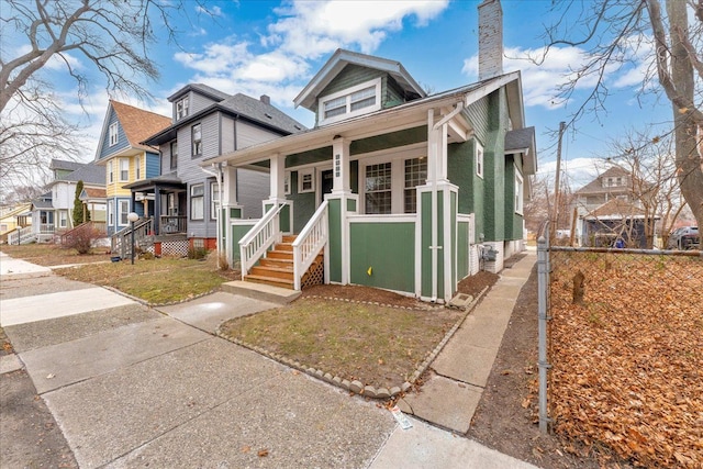 bungalow-style home with a porch and a front yard