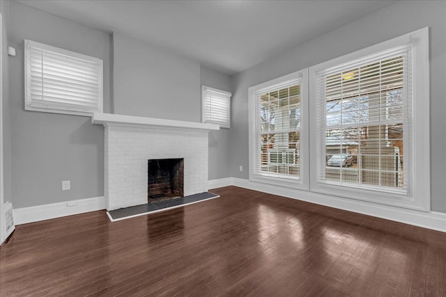 unfurnished living room featuring a fireplace and wood-type flooring