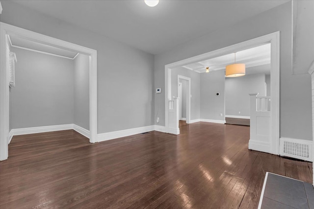 unfurnished living room featuring dark hardwood / wood-style flooring