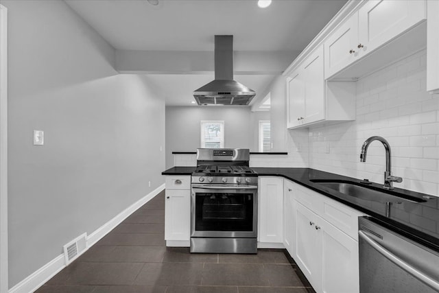 kitchen featuring white cabinetry, range hood, and appliances with stainless steel finishes