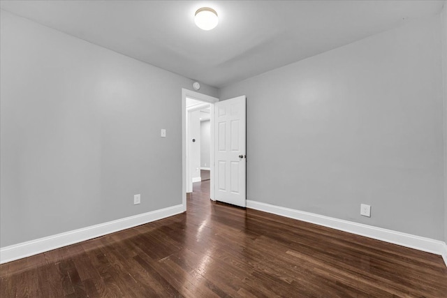 unfurnished room featuring dark wood-type flooring