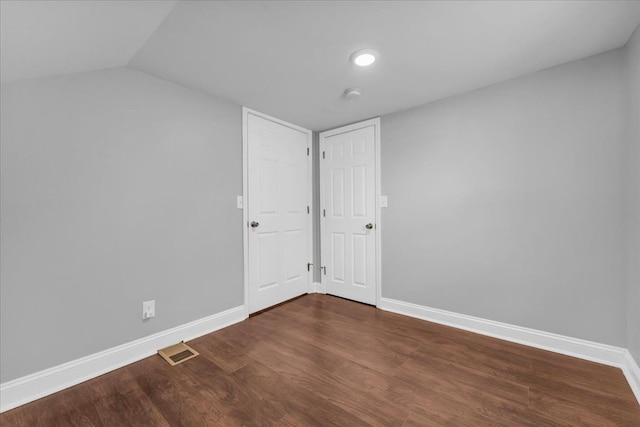 additional living space featuring dark hardwood / wood-style flooring and vaulted ceiling