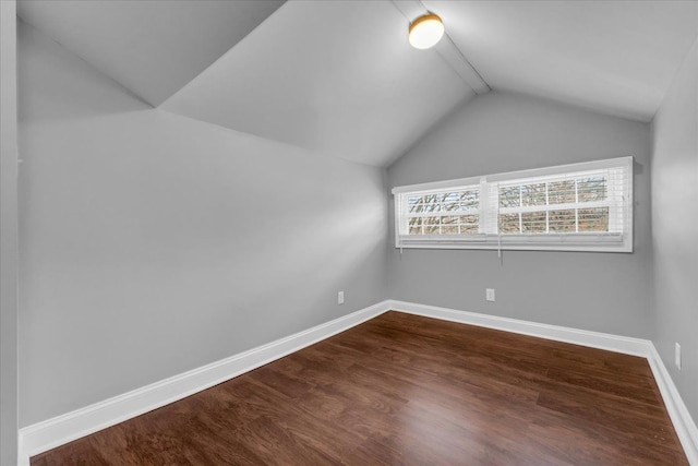 additional living space with dark hardwood / wood-style floors and lofted ceiling