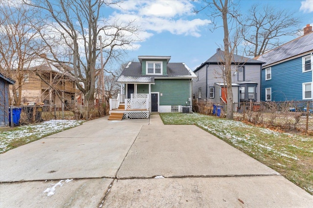 back of property featuring a lawn and central air condition unit