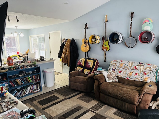 living room featuring a notable chandelier and light tile patterned floors