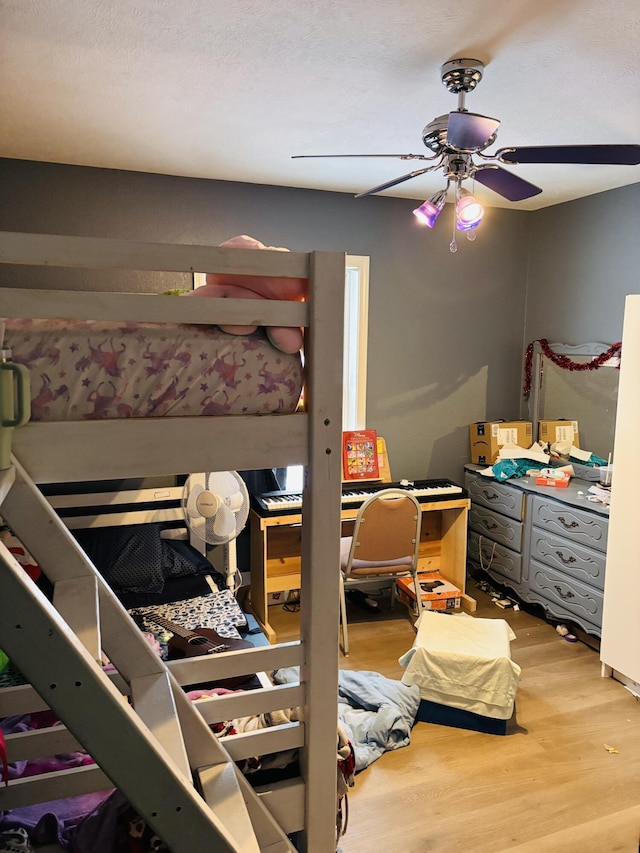 bedroom with ceiling fan and hardwood / wood-style floors