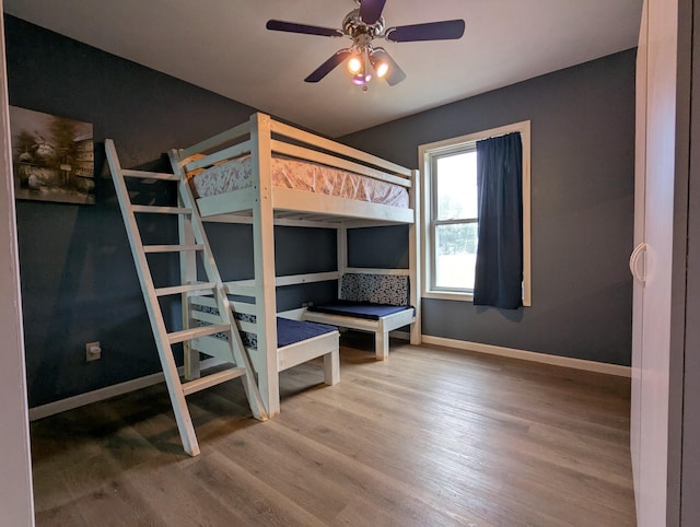 unfurnished bedroom featuring ceiling fan and hardwood / wood-style flooring