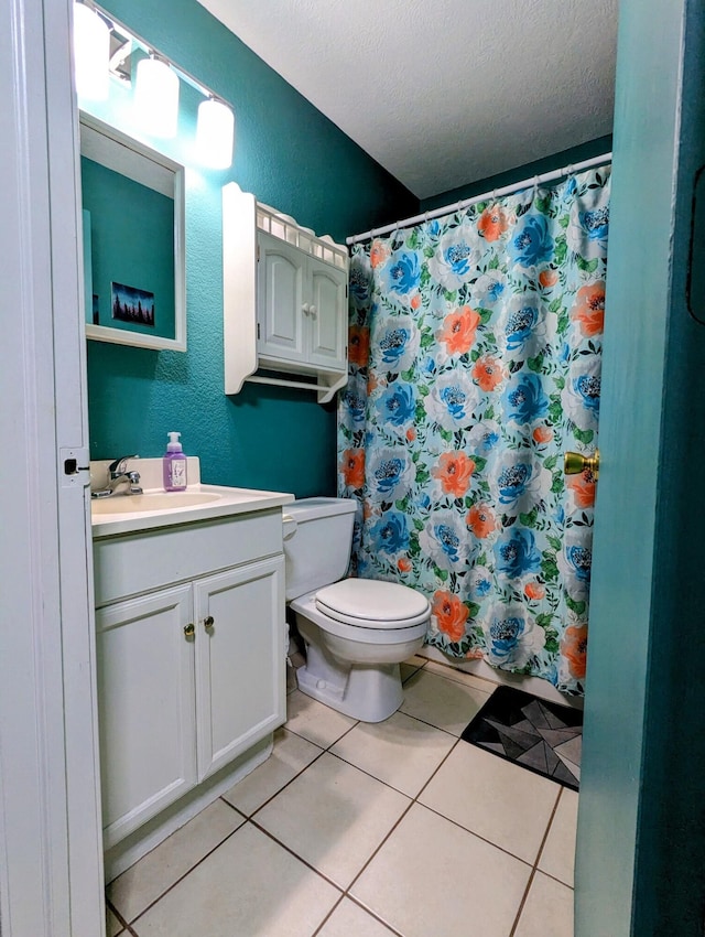 bathroom featuring tile patterned floors, vanity, a textured ceiling, toilet, and curtained shower