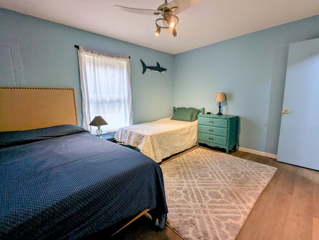 bedroom with hardwood / wood-style flooring and ceiling fan