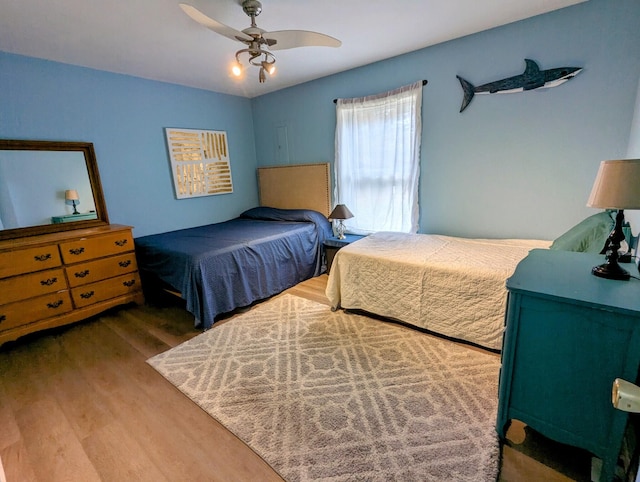 bedroom with ceiling fan and wood-type flooring