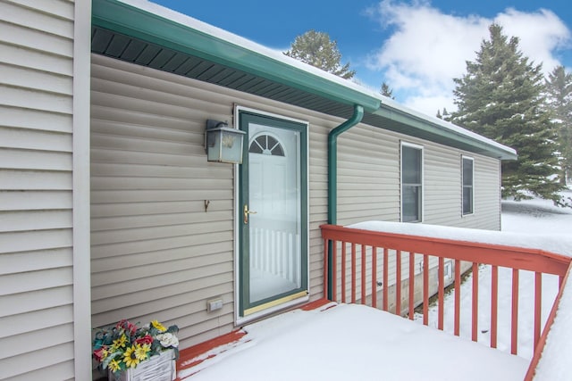 view of snow covered property entrance