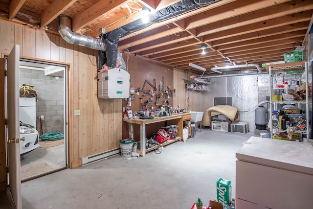 basement with a workshop area and baseboard heating