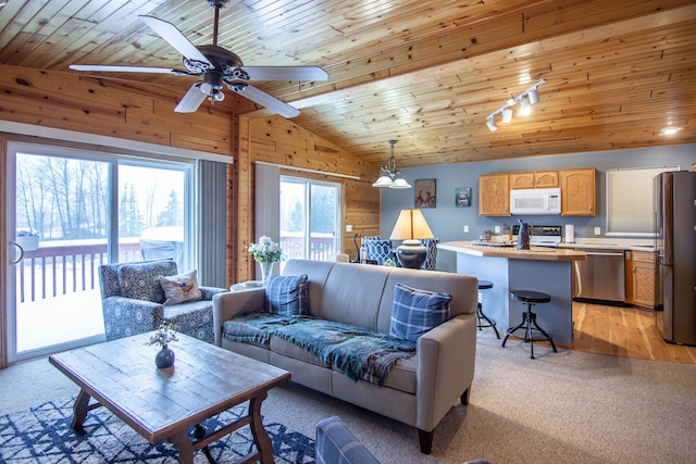 carpeted living room featuring vaulted ceiling with beams, ceiling fan, wooden ceiling, and wood walls