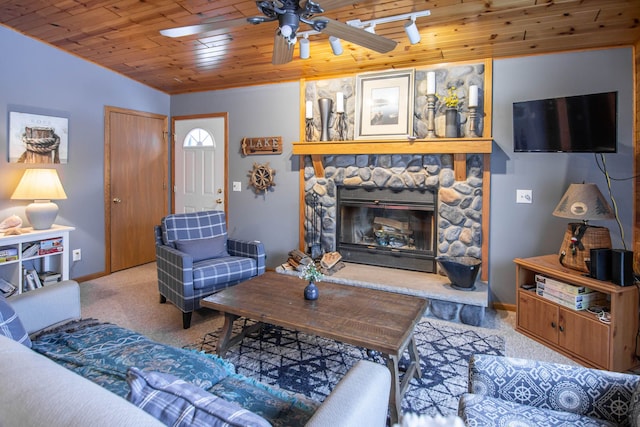 living room with ceiling fan, a stone fireplace, wooden ceiling, and light carpet