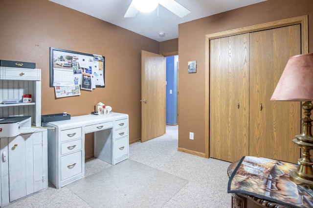 carpeted home office with ceiling fan