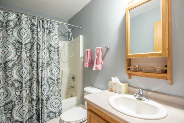 full bathroom with shower / tub combo with curtain, vanity, and toilet