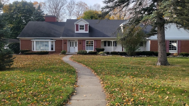 new england style home featuring a front yard