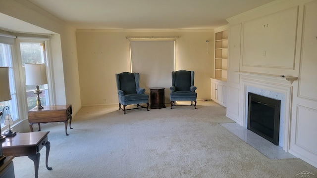 living area featuring light colored carpet, built in features, and crown molding