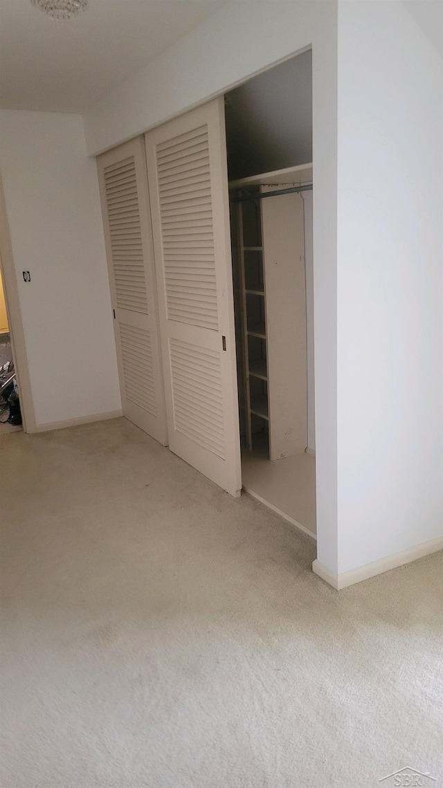 unfurnished bedroom featuring carpet floors and a closet