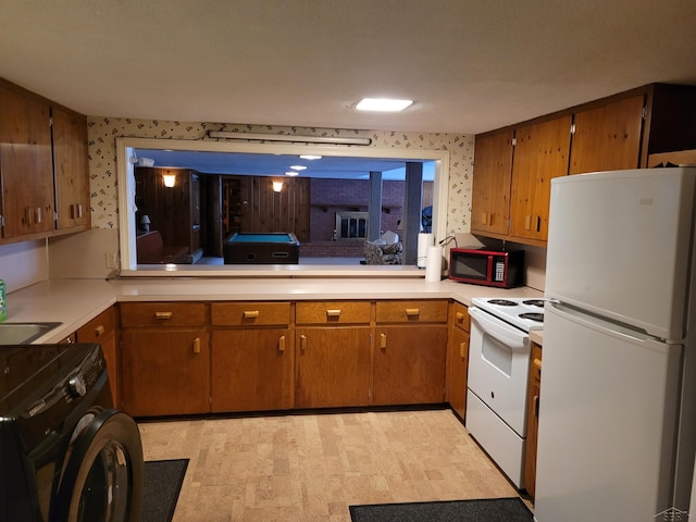 kitchen with washer / dryer, white appliances, sink, and pool table