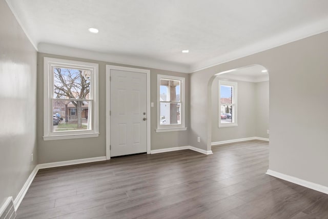 entryway with dark hardwood / wood-style flooring and ornamental molding