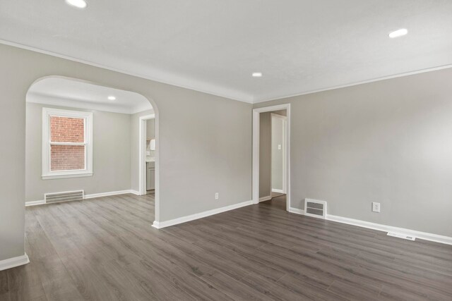 unfurnished room featuring dark hardwood / wood-style flooring and crown molding