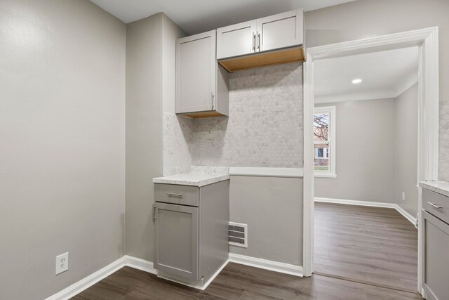 kitchen with gray cabinetry, decorative backsplash, and dark hardwood / wood-style floors