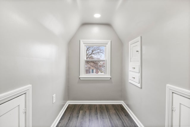 bonus room with dark hardwood / wood-style flooring and vaulted ceiling