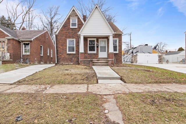 bungalow-style home with a front yard