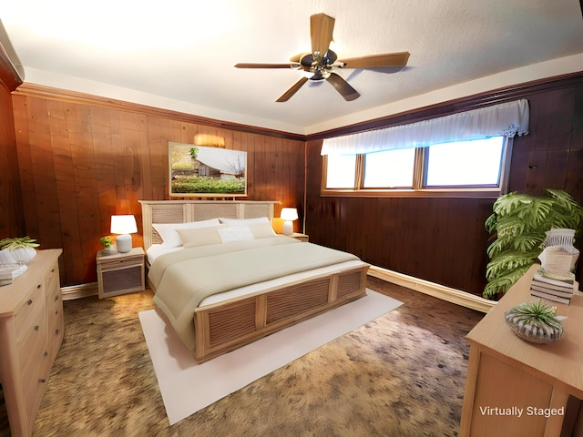 carpeted bedroom featuring ceiling fan and wood walls