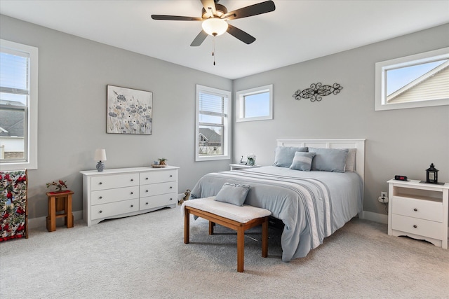 bedroom with ceiling fan and light carpet