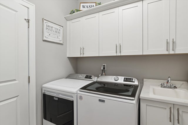 laundry room with sink, cabinets, and independent washer and dryer