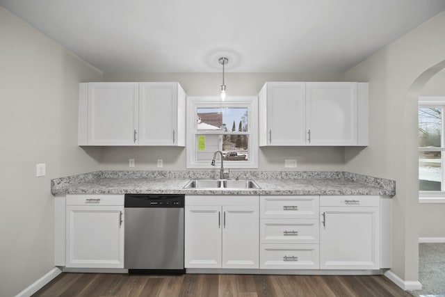 kitchen with dark hardwood / wood-style flooring, sink, dishwasher, white cabinetry, and hanging light fixtures