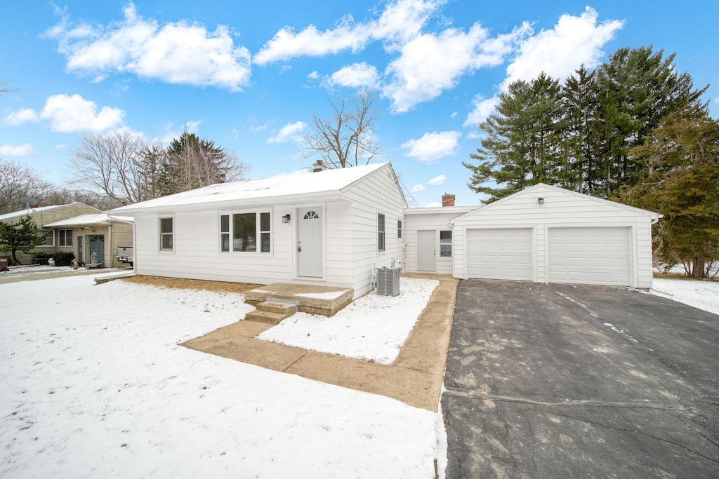 view of front of house with an outbuilding, central AC, and a garage