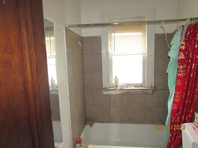 bathroom with shower / bath combination with curtain