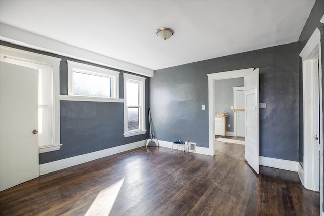 unfurnished room featuring dark hardwood / wood-style flooring