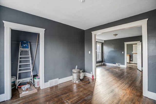 empty room with dark wood-type flooring