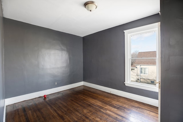 unfurnished room featuring dark wood-type flooring