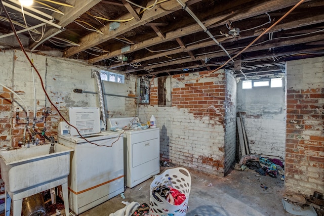 basement featuring independent washer and dryer and sink