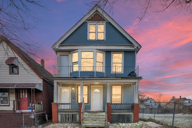 view of front of property featuring covered porch and a balcony