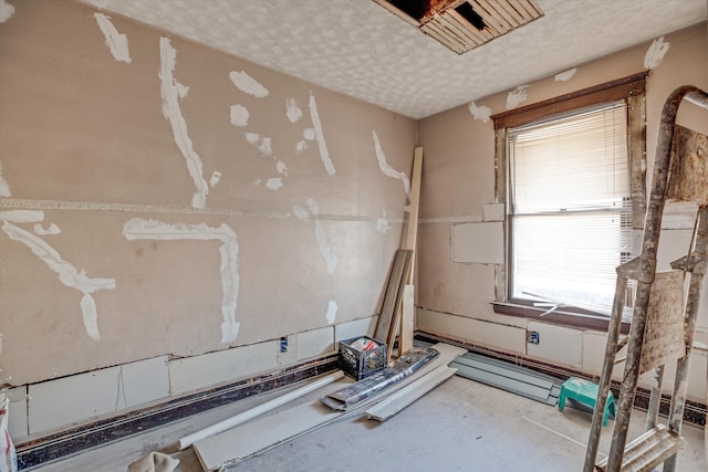 unfurnished room featuring a textured ceiling