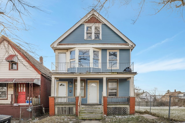 view of front of property with a balcony and covered porch