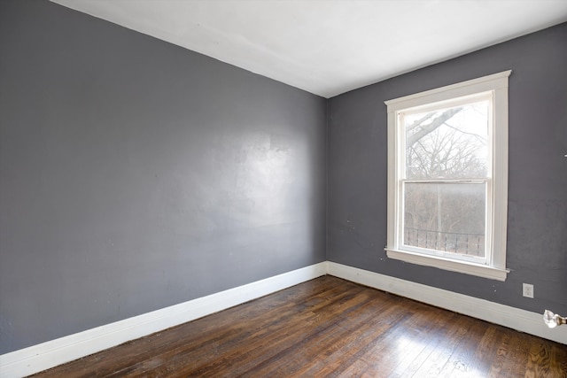 spare room with dark wood-type flooring