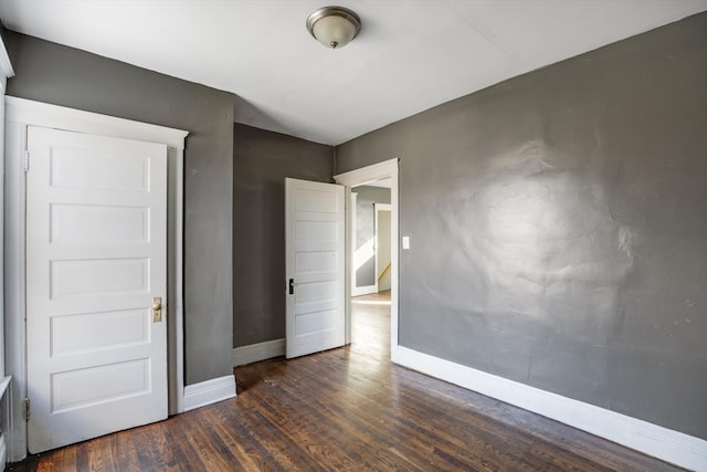 unfurnished room featuring dark hardwood / wood-style floors