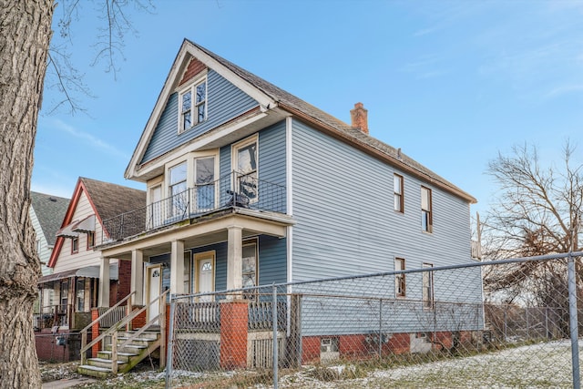 view of front of house with covered porch and a balcony