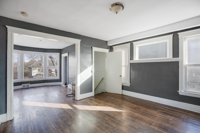 unfurnished room featuring dark hardwood / wood-style flooring