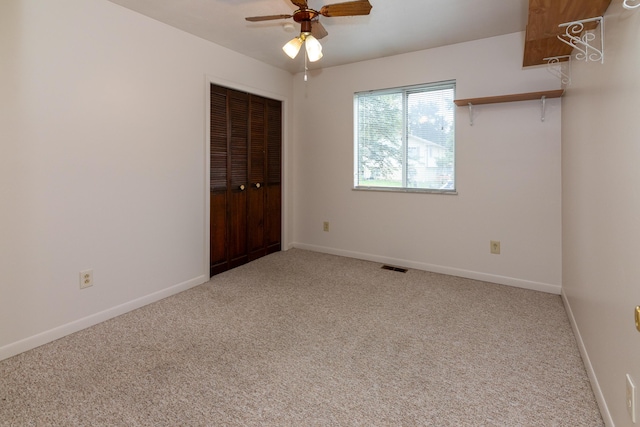 spare room with carpet flooring and ceiling fan