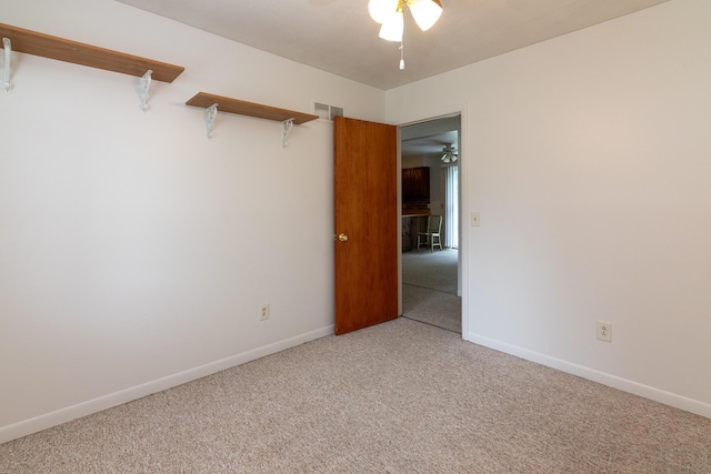 spare room with carpet flooring and ceiling fan