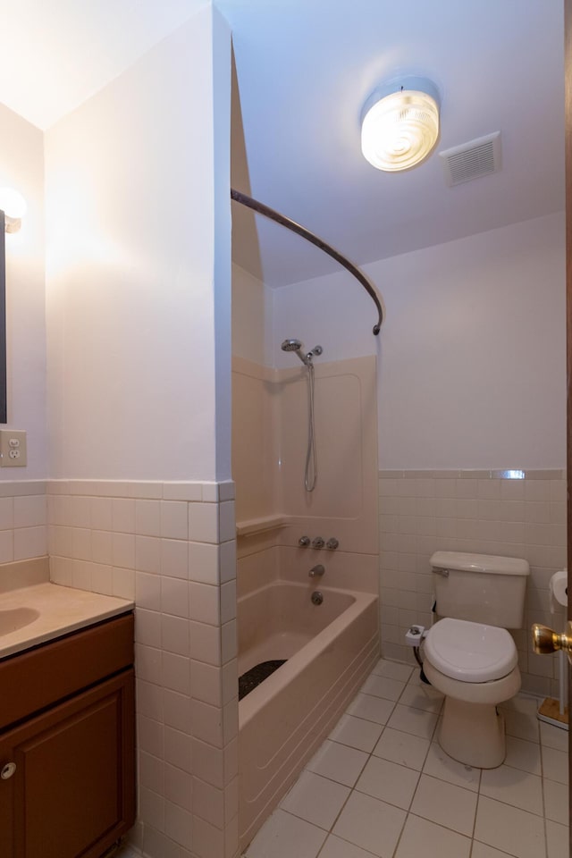 full bathroom with vanity, shower / bathing tub combination, tile walls, tile patterned flooring, and toilet