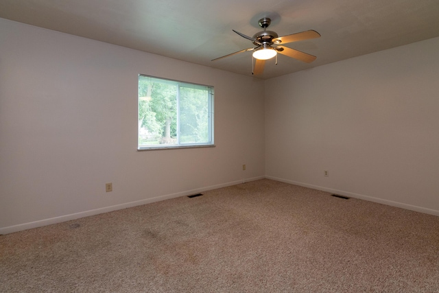 empty room featuring carpet flooring and ceiling fan